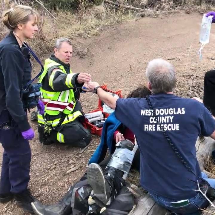 Firefighters providing medical care to a patient during an emergency response.