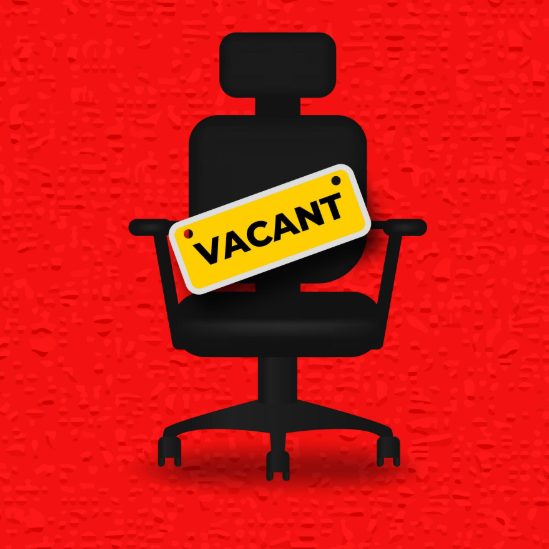 Black office chair with a "VACANT" sign on a bright red background.